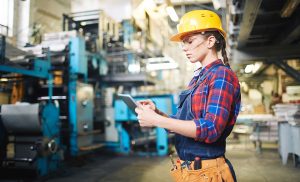 Young female worker using touchpad